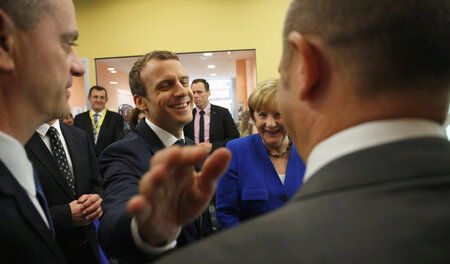 Ein Klaps für den Zweitplatzierten: Emmanuel Macron und Olaf Sch... Ein Klaps für den Zweitplatzierten: Emmanuel Macron und Olaf Sch...