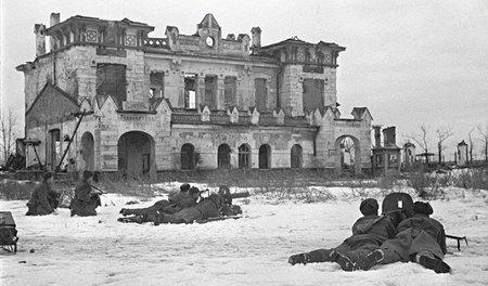 Soviet machine-gunners firing at the enemy near the old train st
