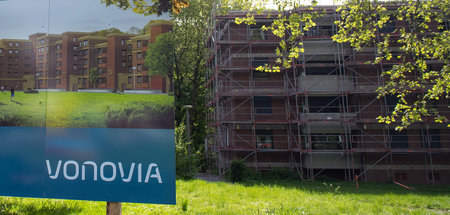 Werbeschild in Dortmund weist vor eingerüstetem Wohnblock auf Wo...