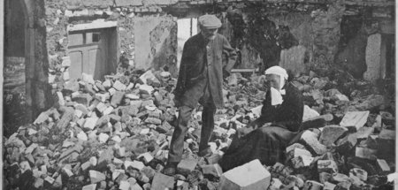 An old French couple visiting their former house in the devastat