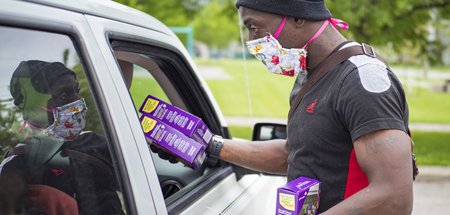 Ein freiwilliger Helfer der Emergency Food Distribution verteilt