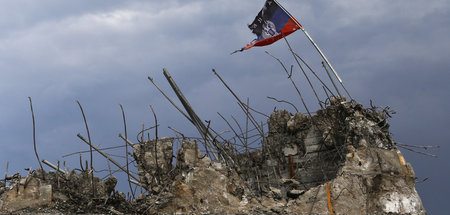 Flagge der Donezker »Volksrepublik« auf den Trümmern eines Krieg...