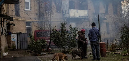 Unter Beschuss: Menschen vor einem beschädigten Haus in Bachmut ...