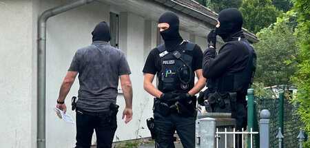 Polizisten bei einer Durchsuchung im Zusammenhang mit dem Compac...