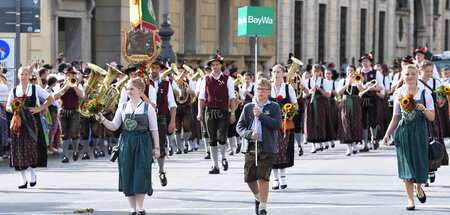 Folkloristischer Aufzug der Trachtengruppe mit Emblem eines Sani...