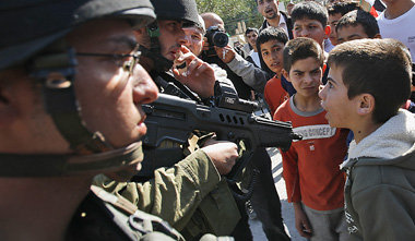 Israelische Soldaten bedrohen palästinensische Kinder bei einer ...