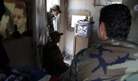 Syrische Soldaten lauschen einer TV-Ansprache ihres Präsidenten ...