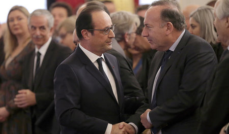 Arbeiten Hand in Hand: Frankreichs Präsident François Hollande u... Arbeiten Hand in Hand: Frankreichs Präsident François Hollande u...