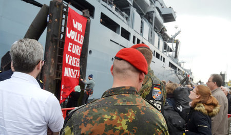 Samstag am Hamburger Hafen: Kriegsgegner befestigen ein Spruchba...