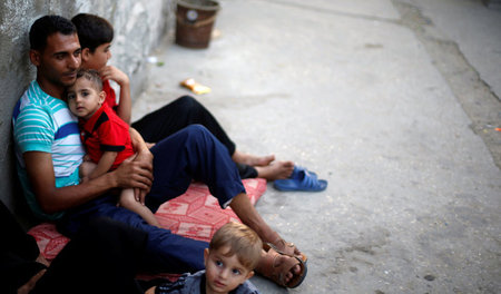 Hitzewelle in Gaza-Stadt: Palästinenser sitzen im Schatten vor i...