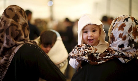 Eine syrische Frau trägt in einem jordanischen Flüchtlingscamp i...