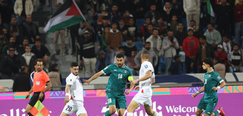 Iraqi striker Ayman Hussein battling the Palestinian defense (March 25, 2025).